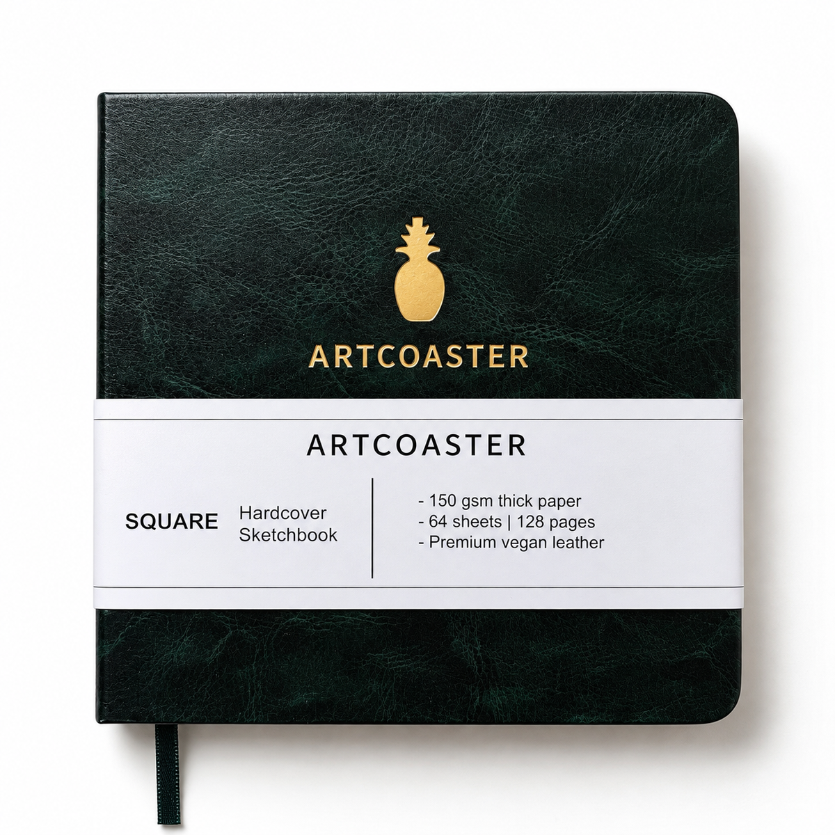 A square Artcoaster sketchbook in dark green textured leather cover with a white paper band around the middle. The cover features a gold pineapple logo and the brand name 'ARTCOASTER' in gold.
