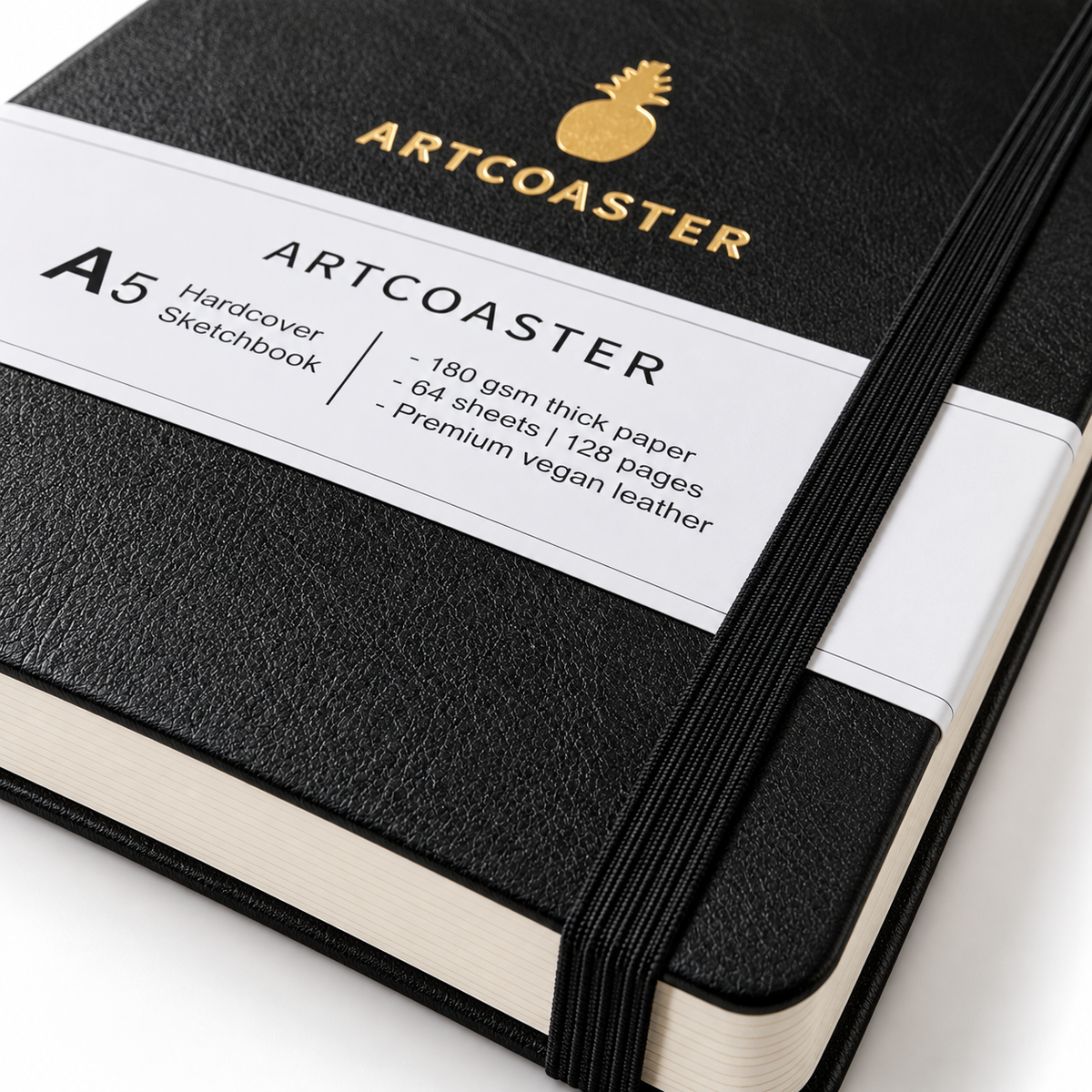 A close-up of an Artcoaster A5 Hardcover Sketchbook with a textured black cover, a white paper band, and a black elastic closure, set against a clean white background.